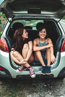 people sitting in a car boot