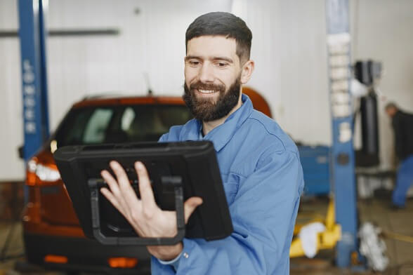 Mechanic looks at a tablet